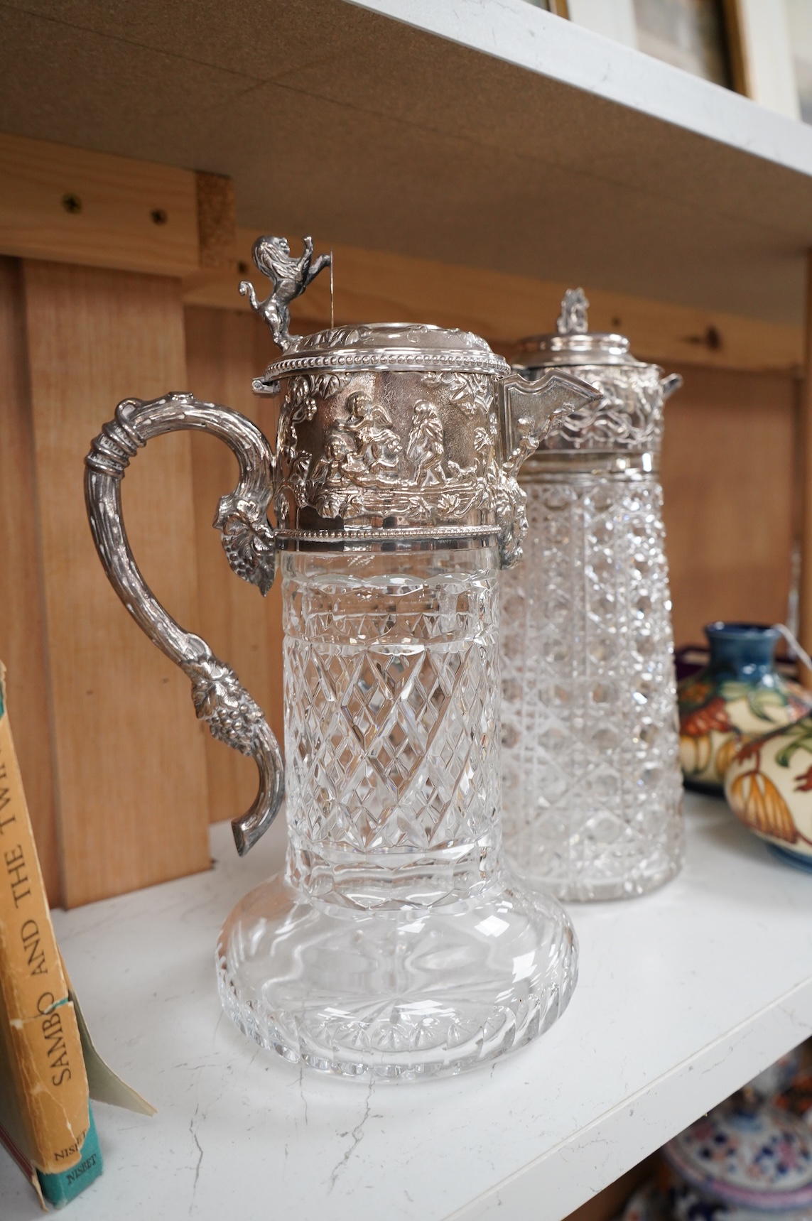 A silver plate mounted glass lemonade jug and a similar claret jug, largest 29cm high